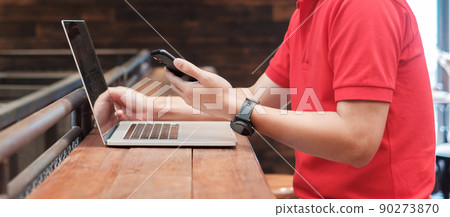 Casual Businessman using smartphone and laptop, freelance man typing keyboard computer notebook in cafe or modern office. technology, digital online and network concept 90273870