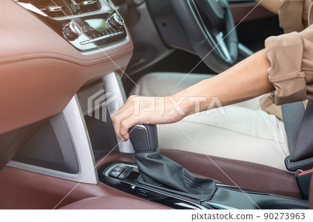 woman driver stick shift transmission a car gear, hand controlling steering wheel during vehicle moving. Journey, trip and safety Transportation concepts woman driver stick shift transmission a car gear, hand controlling steering wheel during vehicle moving. Journey, trip and safety Transportation concepts 90273963