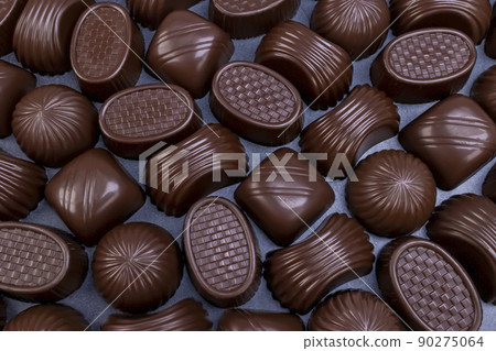 Dark chocolate assorted pralines on table Dark chocolate assorted pralines on table 90275064