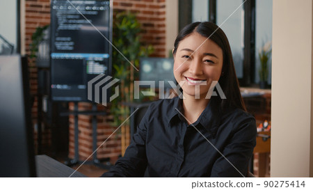 Smiling software developer typing machine learning app code on computer keyboard sitting at desk in big data office. Friendly cloud programer working casually in cyber security agency. Smiling software developer typing machine learning app code on computer keyboard sitting at desk in big data office. Friendly cloud programer working casually in cyber security agency. 90275414