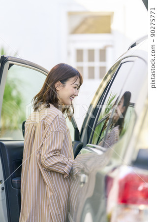 Woman going out by car 90275771