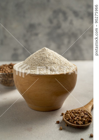 Buckwheat flour in wooden bowl, buckwheat grain, gluten free flour concept. Healthy food Buckwheat flour in wooden bowl, buckwheat grain, gluten free flour concept. Healthy food 90275966