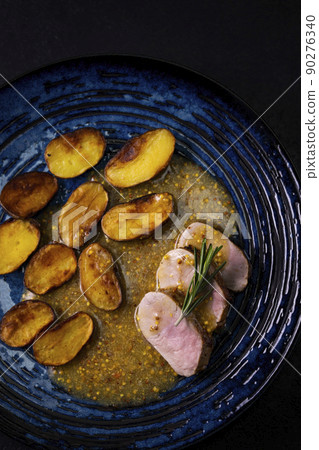 pork tenderloin with baked potatoes and French coarse mustard sauce pork tenderloin with baked potatoes and French coarse mustard sauce 90276340