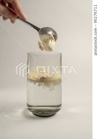 Protein powder and a spoon with glass of water. Food supplements Protein powder and a spoon with glass of water. Food supplements 90276711