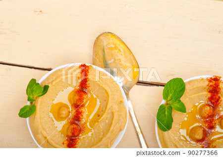 Hummus with mint on top 90277366