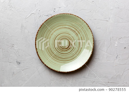 Top view of empty green plate on cement background. Empty space for your design Top view of empty green plate on cement background. Empty space for your design 90278555