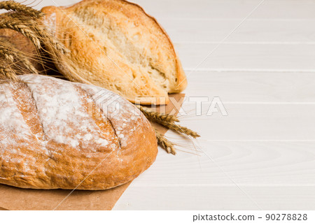 Homemade natural breads. Different kinds of fresh bread as background, perspective view with copy space Homemade natural breads. Different kinds of fresh bread as background, perspective view with copy space 90278828