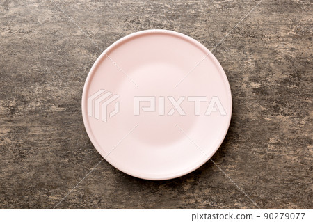 Top view of empty pink plate on cement background. Empty space for your design Top view of empty pink plate on cement background. Empty space for your design 90279077