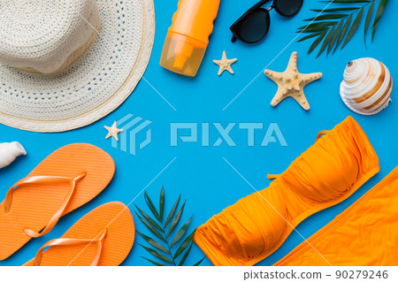 Woman swimwear and beach accessories flat lay top view on colored background Summer travel concept. bikini swimsuit, straw hat and seasheels. Copy space Top view Woman swimwear and beach accessories flat lay top view on colored background Summer travel concept. bikini swimsuit, straw hat and seasheels. Copy space Top view 90279246