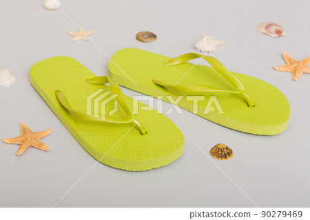 Beach accessories. Flip flops and starfish on colored background. Top view Mock up with copy space Beach accessories. Flip flops and starfish on colored background. Top view Mock up with copy space 90279469