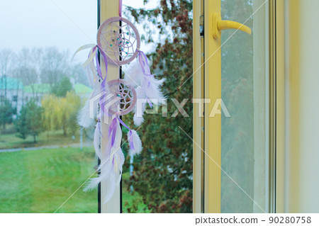 dream catcher on an open window dream catcher on an open window 90280758