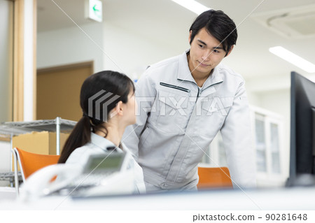 Men and women in work clothes working in the office Men and women in work clothes working in the office 90281648