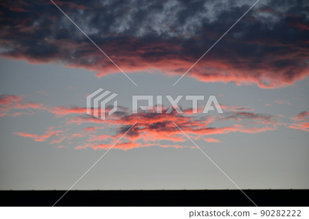 The sky where the clouds are dyed red at dusk under the black clouds The sky where the clouds are dyed red at dusk under the black clouds 90282222