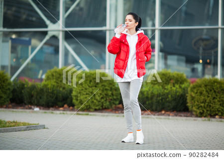 Pretty woman doing fitness outdoors listening to music Pretty woman doing fitness outdoors listening to music 90282484