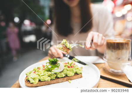 Guacamole avocado healthy food and asian woman background at outdoor restaurant on day Guacamole avocado healthy food and asian woman background at outdoor restaurant on day 90283946