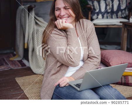 Middle aged female studying at home with laptop. Middle aged female studying at home with laptop. 90285771