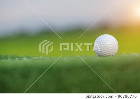 Golf ball on Green field golf course in morning time with soft sunlight. Golf ball on Green field golf course in morning time with soft sunlight. 90286776