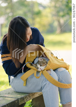 asian woman feel happy during relax and play with her cat at park asian woman feel happy during relax and play with her cat at park 90287067