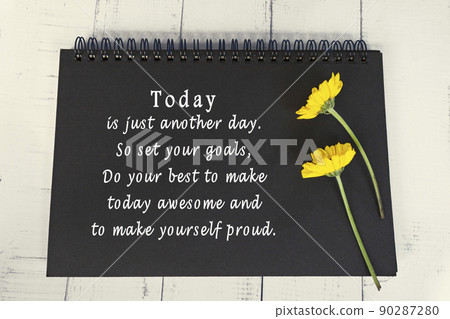 Motivational and inspirational quote on black note book with sunflowers. Motivational and inspirational quote on black note book with sunflowers. 90287280