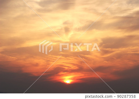 Clouds swelling in the setting sun 90287358