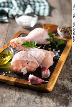 Raw chicken meat legs with spices, herbs and olive oil Raw chicken meat legs with spices, herbs and olive oil 90287462