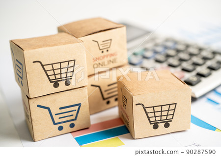 Shopping online box with credit card and calculator on graph. Finance commerce import export business concept. 90287590