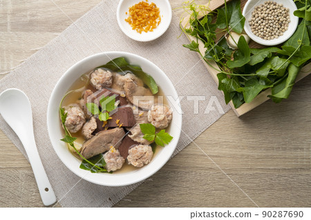 Boiled Pork Blood Soup with gourd leaves,Clear soup asian style food mixed minced pork balls,Pork blood cubes and liver in with bowl,Healthy and Rich in iron and protein 90287690