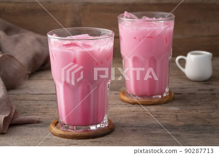 Thai style iced pink milk.Cold sweet drink Red Grenadien Sugar Syrup mix with milk and iced cube in glass Thai style iced pink milk.Cold sweet drink Red Grenadien Sugar Syrup mix with milk and iced cube in glass 90287713