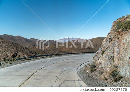 road in the mountains between the cliffs overlooking the snowy hills road in the mountains between the cliffs overlooking the snowy hills 90287876