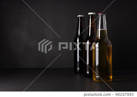 bottles with craft beer on a black background.  Ale or lager from pilsner malt.  homemade home-brewed beer. 90287893