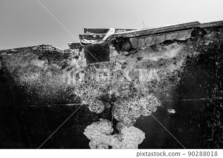 Crumbling concrete under a bridge support rail in need of repair.  90288018