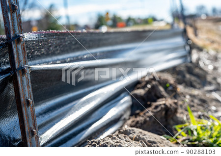 silt fence at a construction site with exposed dirt piled against the fabric silt fence at a construction site with exposed dirt piled against the fabric 90288103