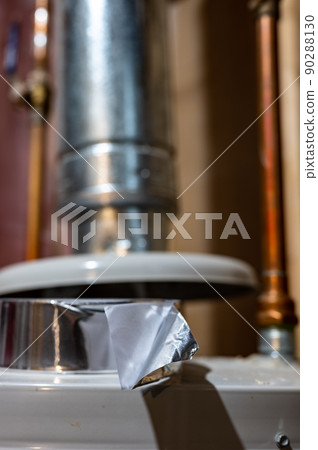 selective focus on the edge of a roll of metallic aluminum foil HVAC duct tape selective focus on the edge of a roll of metallic aluminum foil HVAC duct tape 90288130