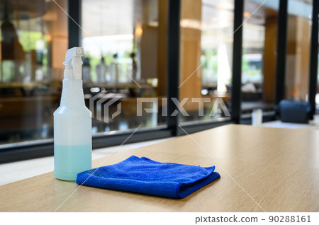 cleaner disinfectant spray bottle with blue microfiber cloth on table. Cleaning products for disinfection. Sanitizer to prevent Coronavirus or Covid-19. Pandemic prevention and control cleaner disinfectant spray bottle with blue microfiber cloth on table. Cleaning products for disinfection. Sanitizer to prevent Coronavirus or Covid-19. Pandemic prevention and control 90288161