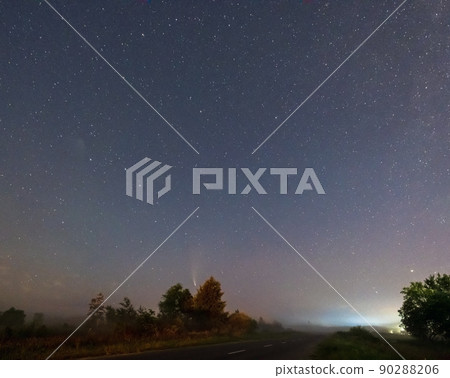 Comet Neowise C2020 F3 as it flies overhead in the summer sky over over meadow near countryside road, Lviv Region, Ukraine. Comet Neowise C2020 F3 as it flies overhead in the summer sky over over meadow near countryside road, Lviv Region, Ukraine. 90288206