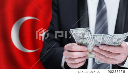 Hands holding dollar money on flag of Turkey 90288656