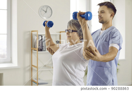 Physiotherapist work with aged patient in rehab clinic 90288863