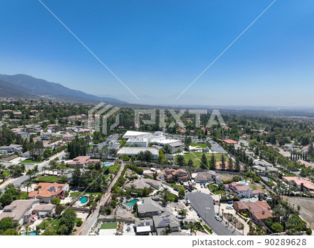 Aerial view of wealthy Alta Loma community and mountain range. 90289628