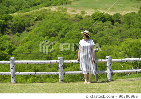 Taking a portrait of a woman at the Kijihiki Kogen Observatory in Hokuto City, Hokkaido in early summer Taking a portrait of a woman at the Kijihiki Kogen Observatory in Hokuto City, Hokkaido in early summer 90290969