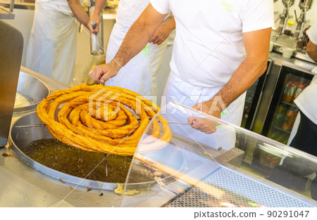 A man making churros in a bar A man making churros in a bar 90291047