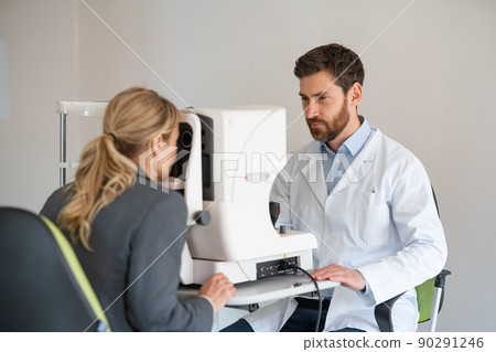 Optometrist checks the patient's intraocular pressure in optician's shop or ophthalmology clinic 90291246