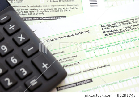 German annual income tax return declaration and calculator lies on accountant table close up. The concept of taxpaying period in Germany 90291743