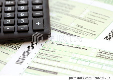 German annual income tax return declaration and calculator lies on accountant table close up. The concept of taxpaying period in Germany German annual income tax return declaration and calculator lies on accountant table close up. The concept of taxpaying period in Germany 90291793