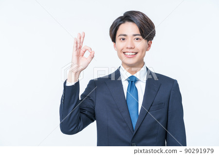 Young male businessman making ok sign 90291979