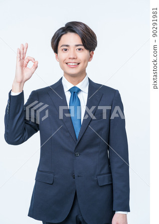 Young male businessman making ok sign 90291981