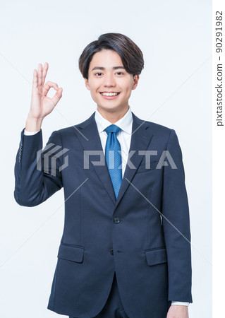 Young male businessman making ok sign Young male businessman making ok sign 90291982