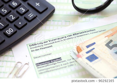 German statement on the assessment of retirement income with calculator and european money close up. The concept of taxation and accountant paperwork Germany German statement on the assessment of retirement income with calculator and european money close up. The concept of taxation and accountant paperwork Germany 90292165