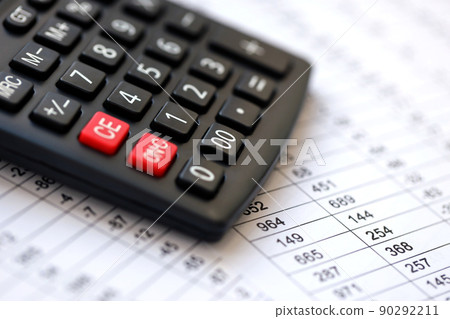 Big black calculator lies on financial statement and balance sheeet on desk of auditor close up. Concept of accounting and audit business. Taxpaying 90292211