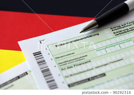 German annual income tax return declaration form with pen on flag close up. The concept of tax reporting in Germany 90292318