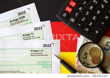 German different tax declaration blank forms - Anlage EUR, Anlage SZ and Anlage Luf. Documents lies with calculator, pen and european money 90292319